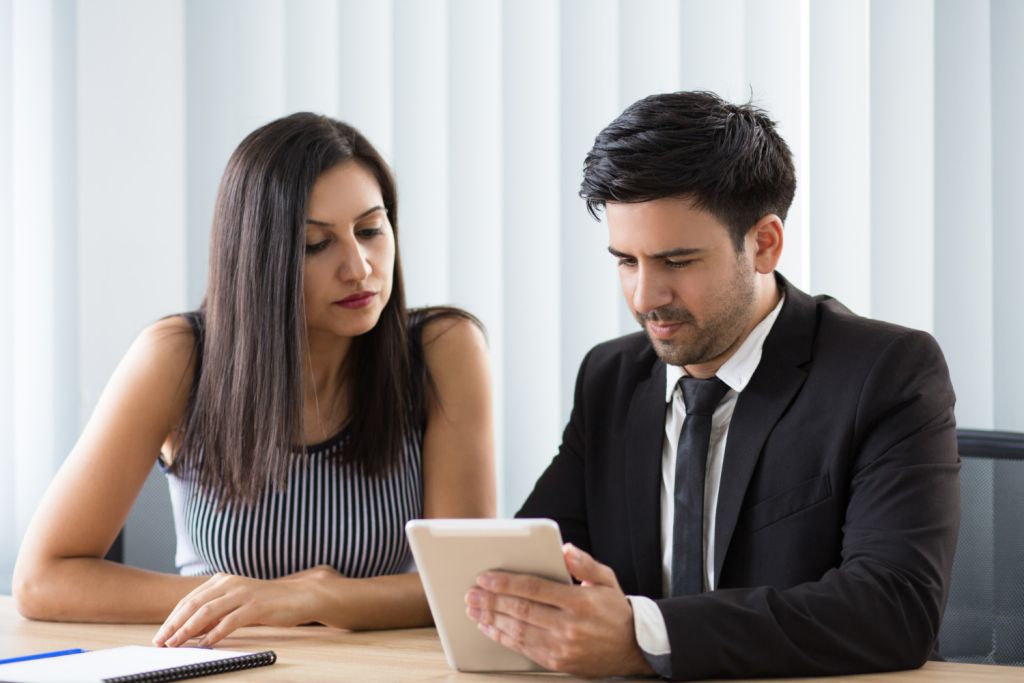 concentrated-multi-ethnic-colleagues-viewing-online-report